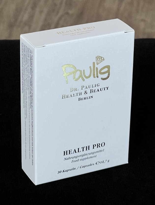 Eine weiße Schachtel von Dr. Paulig mit goldener Schrift und schwarzem Text.